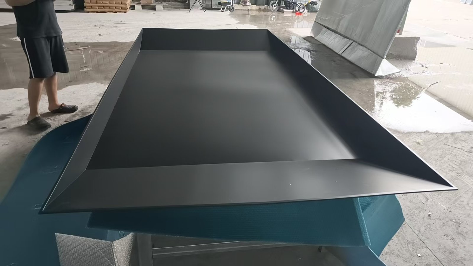 Factory quality check of a large matte black wall niche